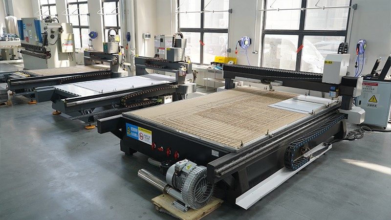 CNC machining centres cutting polycarbonate sheet at the SinoPlastix plant