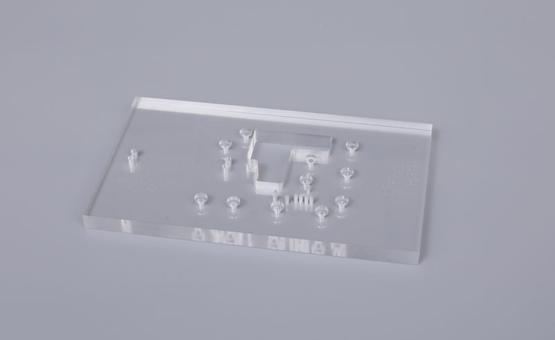 Clear machined sheet component with openings and detailed edges